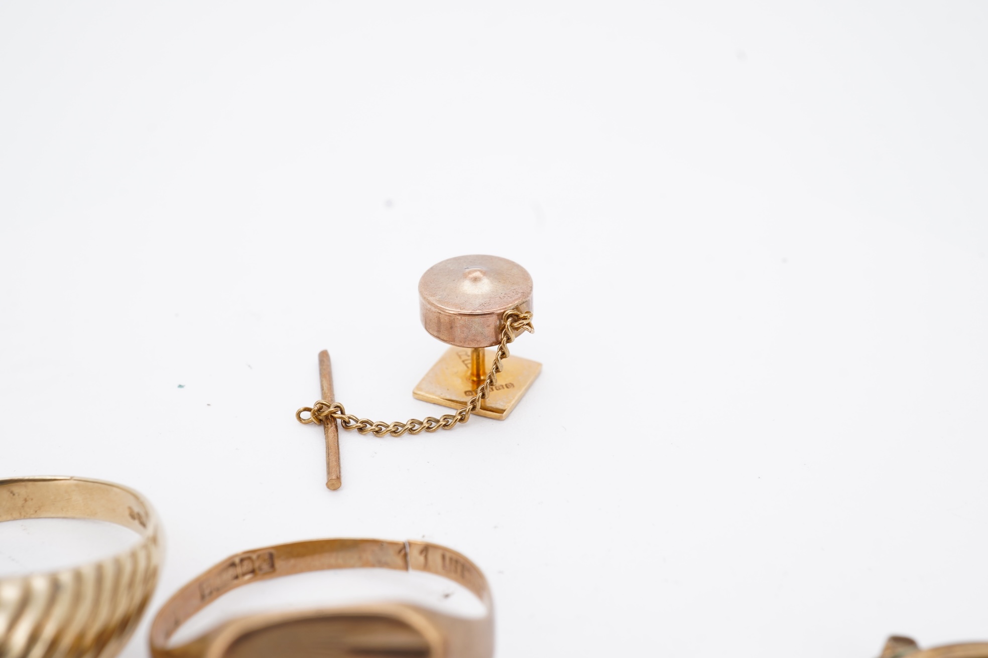 A 1960's 9ct gold and black onyx set signet ring, size X, one other 9ct gold signet ring, a 9ct gold dress stud, a 9ct gold pendant mount and two damaged 9k necklaces, gross weight 21 grams.